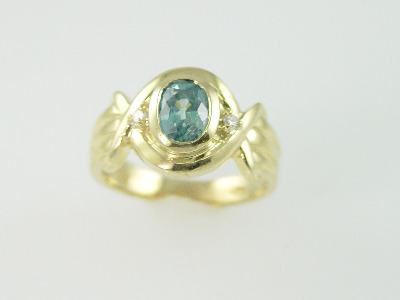 14KT Y/G Bezel Set Blue Zircon 1.70ct and Two Round Diamonds 0.06ct
